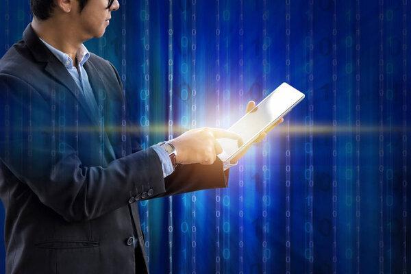 Businessman use tablet for business management on digital technology binary blue screen