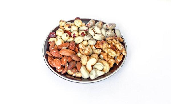 Healthy food. Nuts mix assortment on white grey table top view. Collection of different legumes for background image close up nuts, pistachios, almond, cashew nuts, peanut, walnut. image