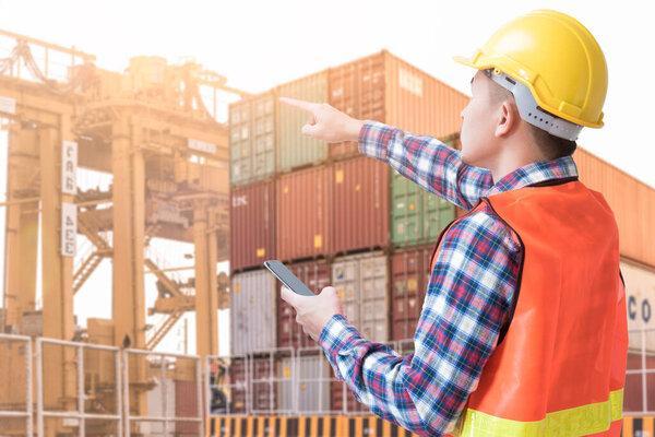 The abstract image of the engineer near container yard during sunrise. the concept of engineering, shipping, shipyard, business and transportations.
