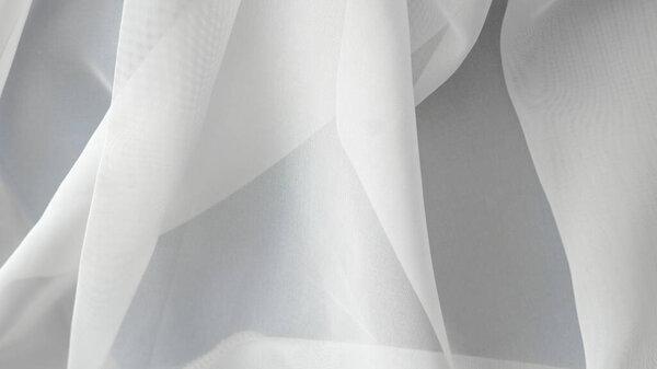 .Smooth white fabric background, minimalist elegance for product presentation or design projects