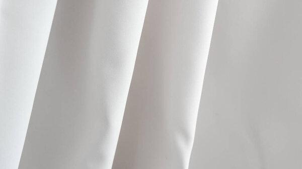 .Smooth white fabric background, minimalist elegance for product presentation or design projects