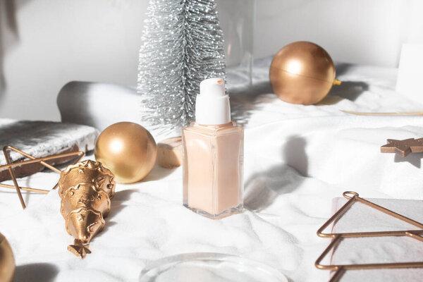 white snow background with lifestyle, cosmetic makeup bottle lotion cream product mockup with beauty fashion skincare for merry christmas festival gift
