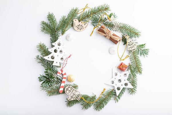Christmas or New Year wreath composition. Decorations, stars, bells, fir and spruce branches, on white background. Top view, copy space, flat lay.