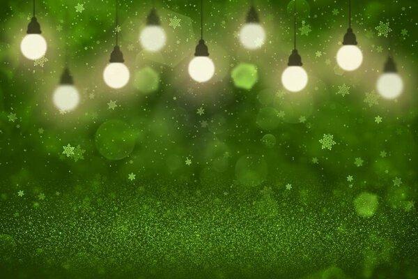 green nice bright abstract background glitter lights with light bulbs and falling snow flakes fly defocused bokeh - holiday mockup texture with blank space for your content