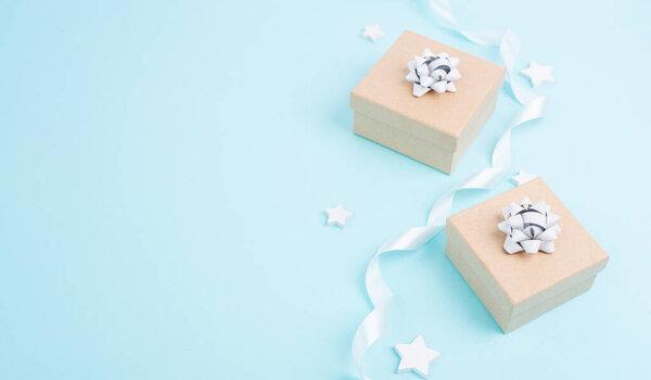 Christmas holiday greeting card with little gift boxes, stars and fir branches, blue background