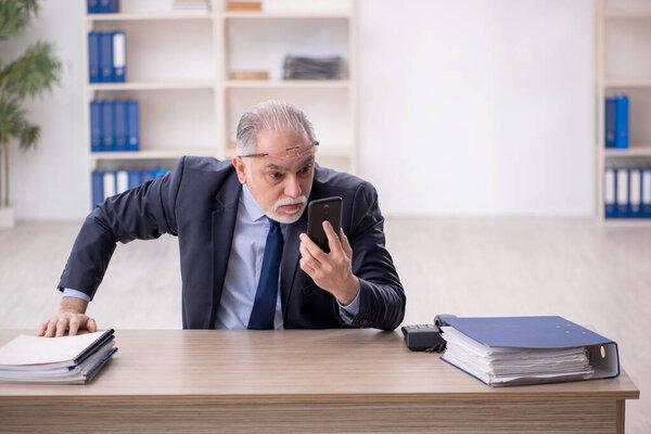 Old employee working at workplace