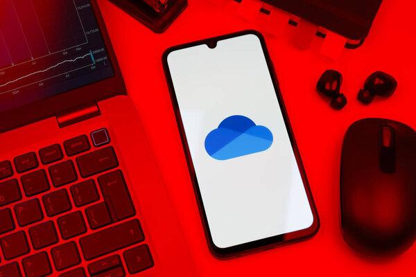 Prague, Czechia - 10 21 2024: Smartphone on surface showing OneDrive logo.