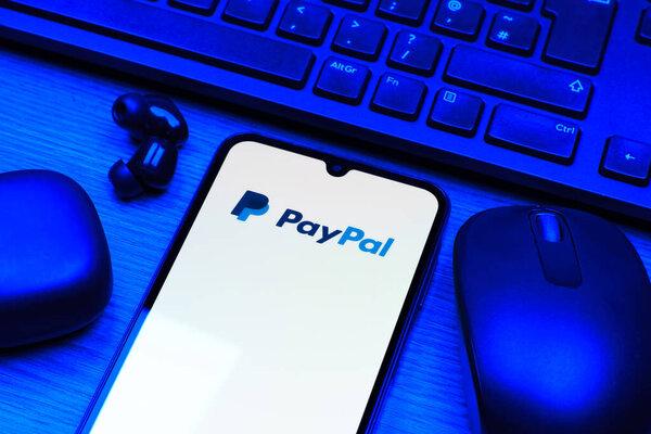 Prague, Czechia - 10 21 2024：Smartphone on surface showing PayPal logo.