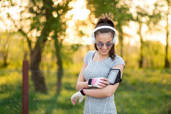 Young sexy sporty woman use smart phone