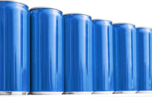 Many blank metal blue cans on table, closeup. Mock up for design 