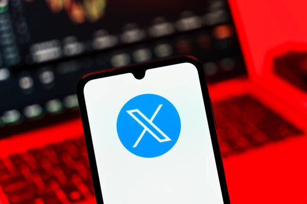 Prague, Czechia - 10 21 2024：Smartphone on surface showing X logo.