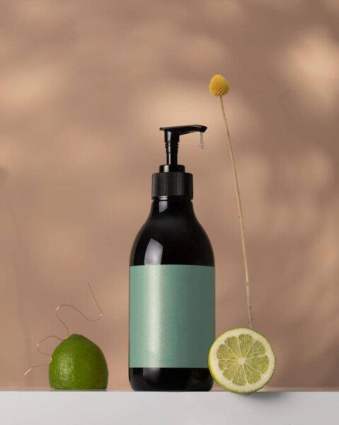 A mock-up of a brown dispenser with a cosmetic product with lime juice in the composition. Cosmetics with natural ingredients. Zero waste.