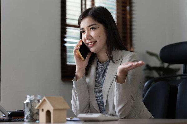 Portrait of Happy asian woman talking with friend by cell phone.